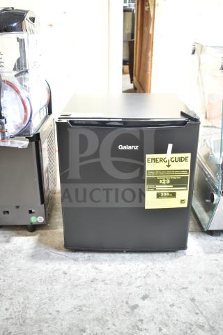Brand new Galanz 1063897 1.7 Cu ft black mini fridge, one-door, slight scratches, visible energy guide label.