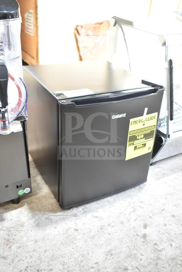 BRAND NEW Galanz 1063897 1.7 Cu ft black mini refrigerator with minor scratches, Energy Guide label visible.