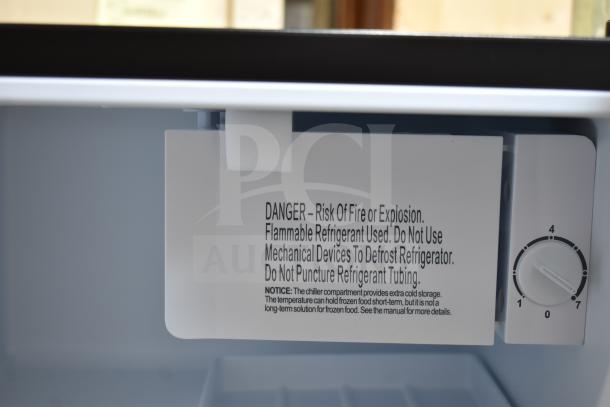 BRAND NEW Galanz 1063897 1.7 Cu ft mini fridge, black. Warning label inside. Scratch and dent condition.