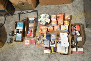 Lot of automotive items including Fram PH4967 Extra Guard filters, Napa and MotoRad thermostats, and towel bars in boxes.