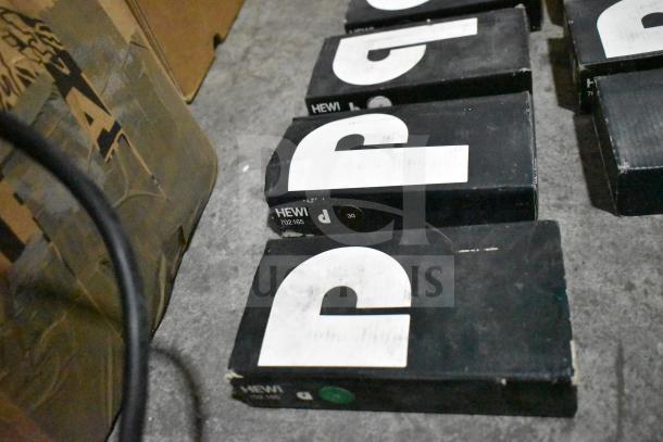 Lot of various items including HEWI boxes, likely towel bars, visible wear, labeled "702.165".