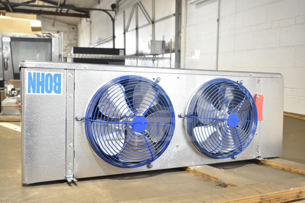 BRAND NEW Bohn BEL0650AG6AMAD2107 evaporator fan, 115 volts, 1 phase. Features two blue fans and branded label.