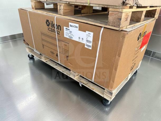 Boxed Ikon ICBR-62 commercial chef base refrigerator, 62" stainless steel, on a pallet, brand new, model info visible.