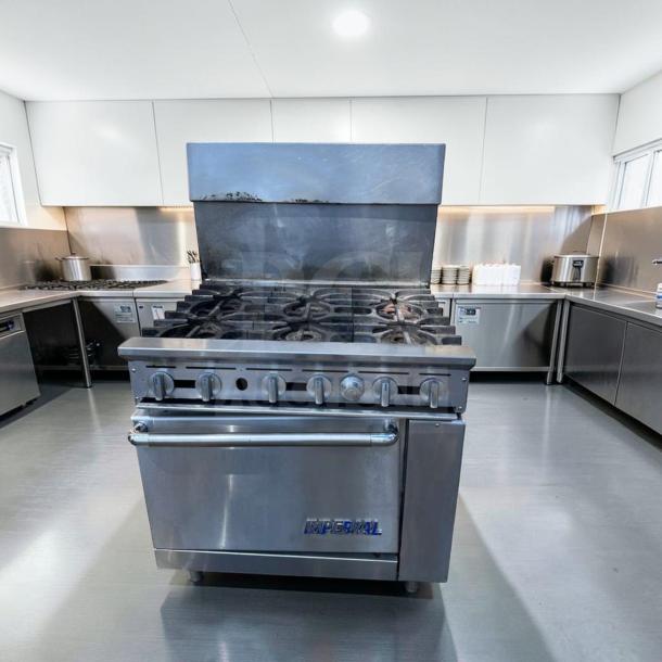 Exceptional condition Imperial IR-6 36" commercial gas range with 6 burners and oven in a professional kitchen.