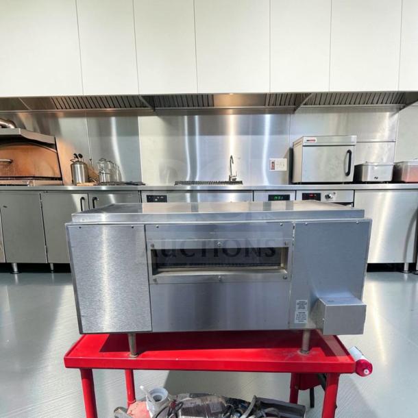 Star Holman QT14 commercial conveyor sandwich toaster oven on red cart in professional kitchen; stainless steel, excellent condition.