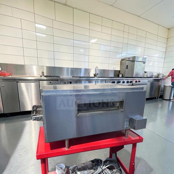 Star Holman QT14 commercial conveyor toaster oven on red stand in a kitchen. Excellent condition, heavy-duty, fully tested.
