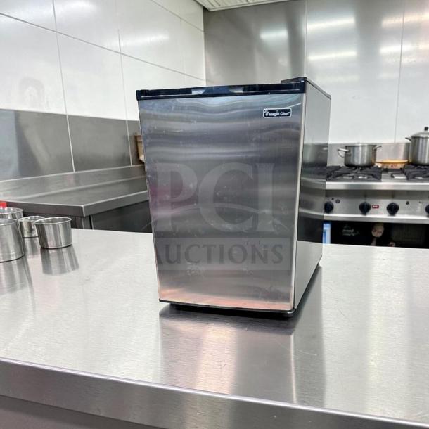 Magic Chef MCUF3S2 3 Cu. Ft. stainless steel compact upright freezer in excellent condition, shown in a kitchen setting.