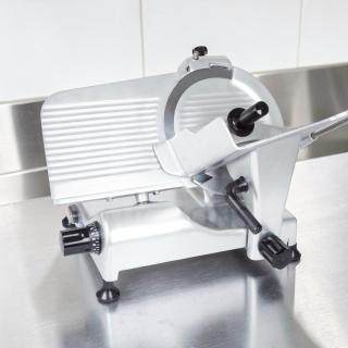 Globe G12 12" commercial manual meat slicer, elite condition, 1/2 HP, heavy-duty gravity feed, fully tested, stainless steel.