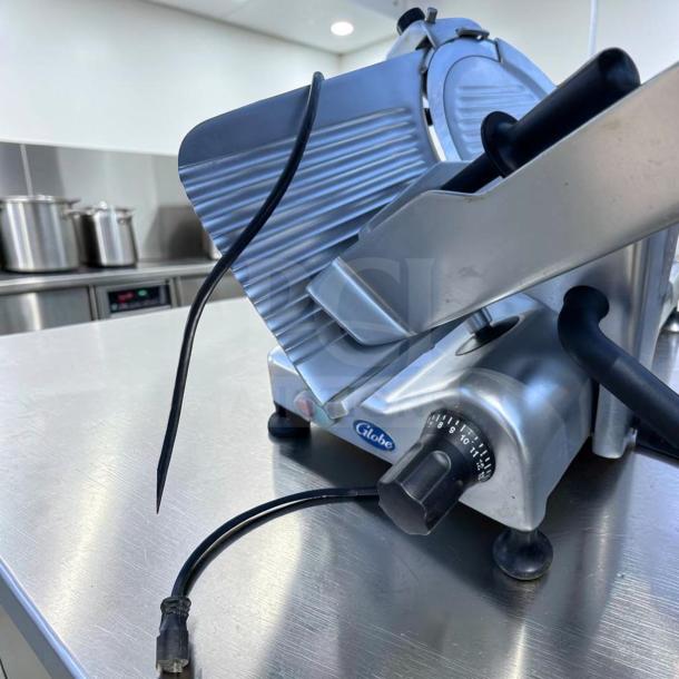 Globe G12 12" commercial meat slicer, heavy-duty gravity feed, fully tested, excellent condition, Globe logo visible.