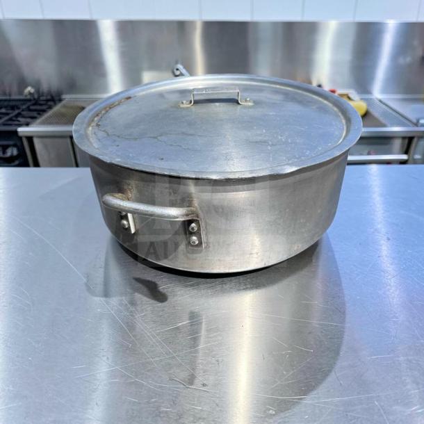 Heavy-duty commercial aluminum stock pot with lid, superior condition, large capacity, inspected, model GEN-S-POT-0897.