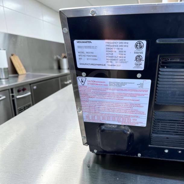 Amana MDC182 Menumaster Commercial Microwave, 1800W, 208-240V, labels showing model details and operational warnings, excellent condition.