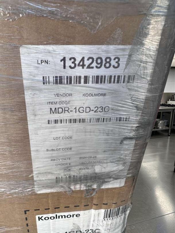 Brand new KoolMore MDR-1GD-23C commercial glass display refrigerator packaging, showing item code and vendor label.