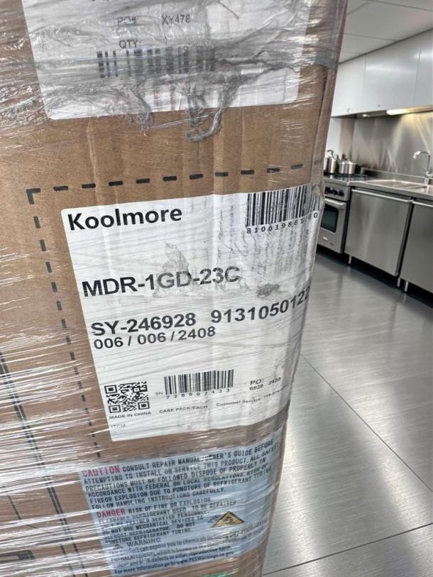 KoolMore MDR-1GD-23C, brand new commercial glass display refrigerator, shown in packaging. Model info and barcode visible.
