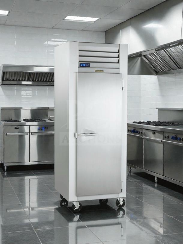 Traulsen G12010 commercial reach-in freezer in excellent condition, with digital display and single door, mounted on wheels.