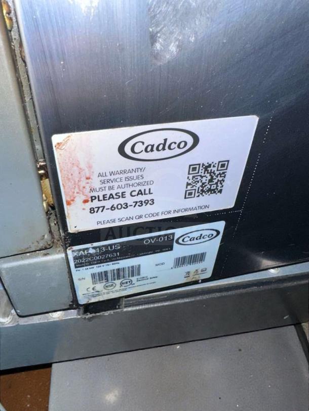 Cadco OV-013/XAF-013-US convection oven label showing model, warranty contact, NSF and UL listings.
