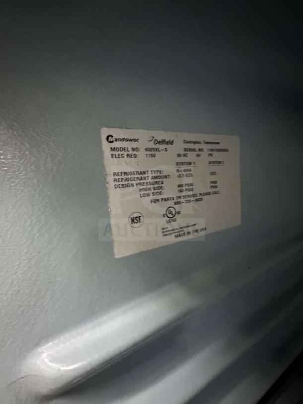 Label on Delfield GSS2TL-8 refrigerator indicates 115V, NSF and UL listed, fully tested, made in USA, premium condition.