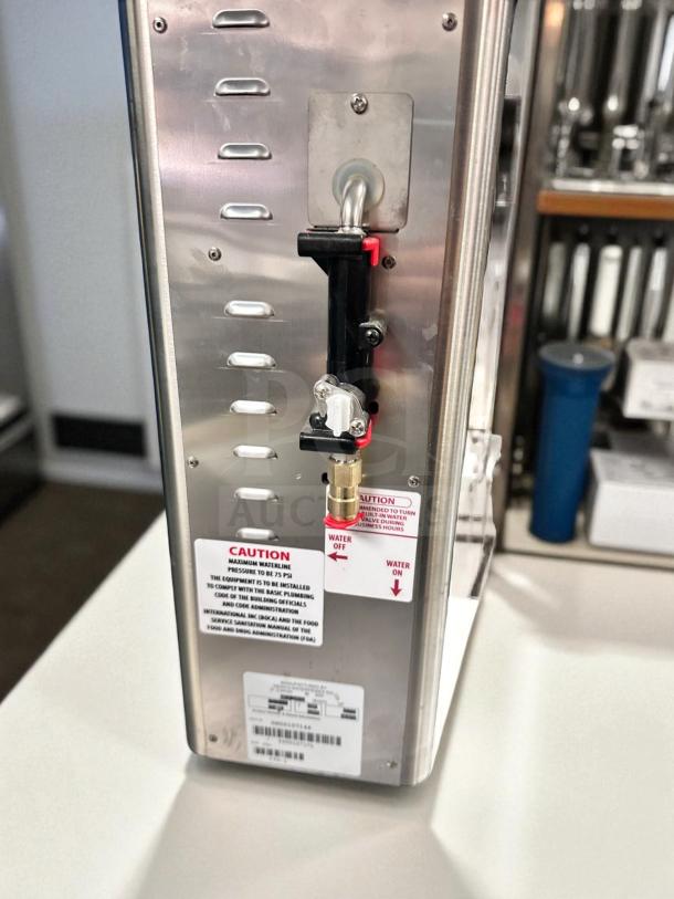 Newco FPM-1 lemonade dispenser, stainless steel, NSF listed, fully operational, caution labels visible, premium condition.