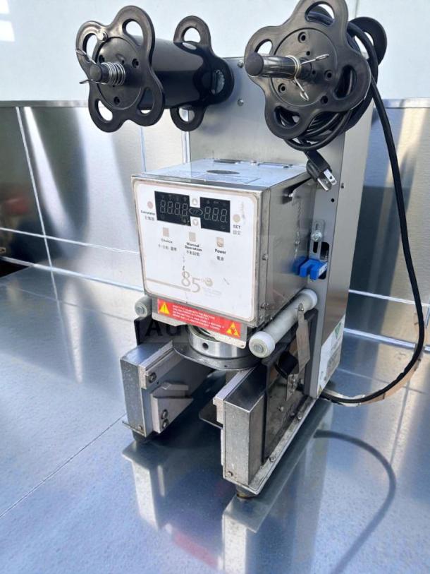 Impressive condition digital cup sealing machine by Commercial Beverage Equipment, model 85°C, fully tested and operational.
