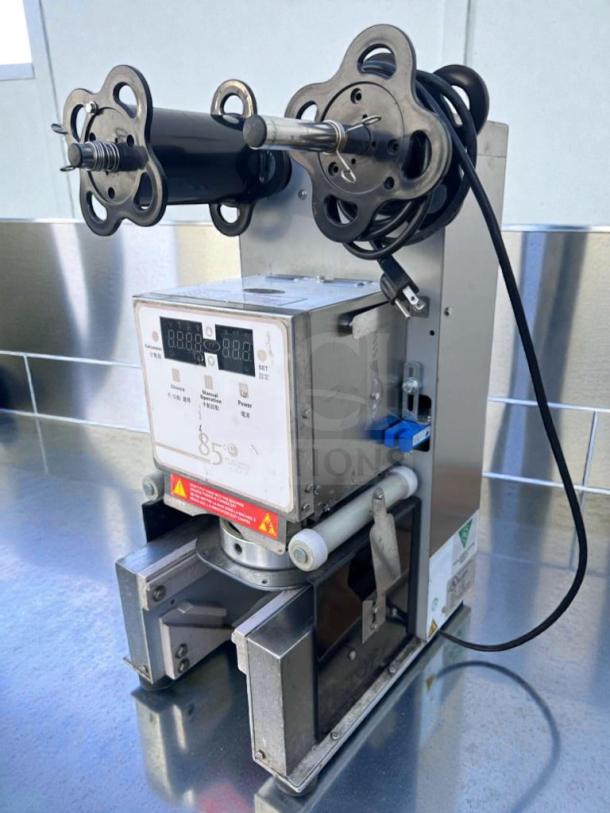Automatic digital cup sealing machine by Commercial Beverage Equipment, model 85°C, in impressive condition, fully tested.