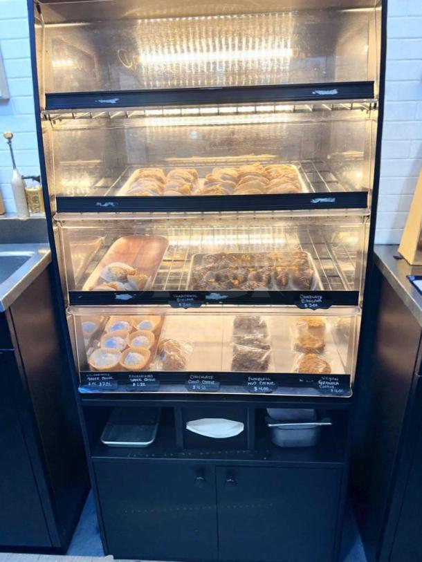 Turbo Air refrigerated bakery display case, LED lit, excellent condition, model TA-L-BDC-0512, showcasing pastries.