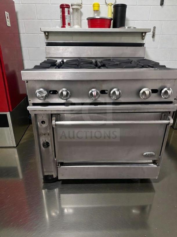 Commercial 6 burner gas range with oven, stainless steel, tested, in superior condition. Model COM-L-RNG-0509.