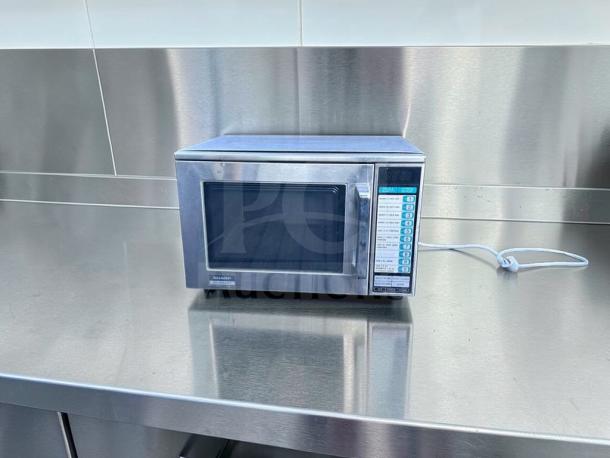 Sharp R-22GT commercial microwave, 1200W, stainless steel, fully tested, excellent condition, 120V, buttons and display visible.
