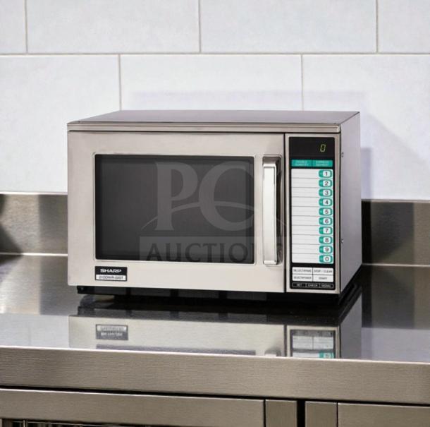 Sharp R-22GT commercial microwave oven, stainless steel, 1200W, tested, superior condition. Model labeling visible.