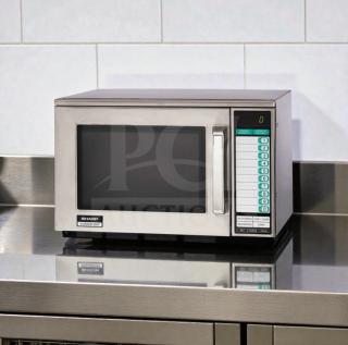 Sharp R-22GT commercial microwave oven, stainless steel, 1200W, tested, superior condition. Model labeling visible.