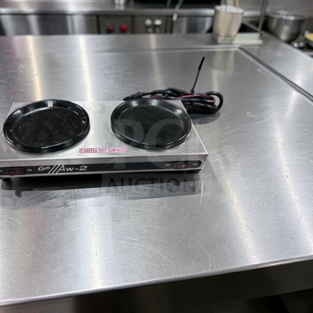 Curtis AW-2-10 two burner coffee decanter warmer, stainless steel, 120V, tested, "Careful Hot Surface" label, excellent condition.