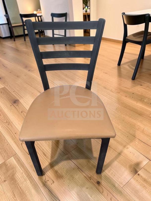 Black metal ladder back dining chair with padded vinyl seat, model CHR-S-DIN-0909, prime condition, ready for use.