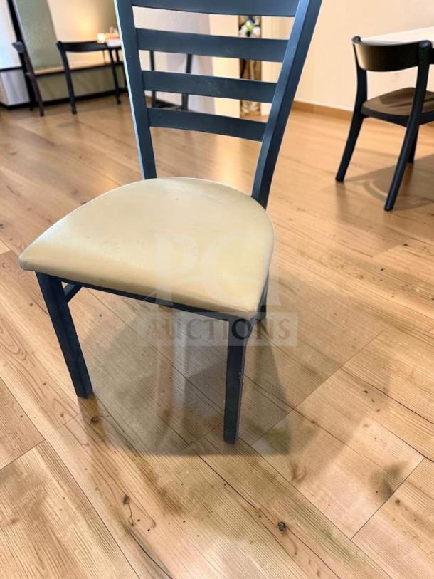 Black metal ladder-back restaurant chair with padded vinyl seat. Prime condition, fully inspected. Set of 5 available.