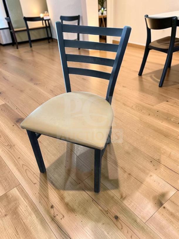 Black metal restaurant dining chair with padded vinyl seat, ladder back style, prime condition, set of 5 available.