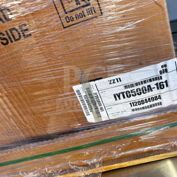 Brand new Manitowoc IYT0500A Indigo NXT ice machine in sealed packaging, showing model and serial labels.