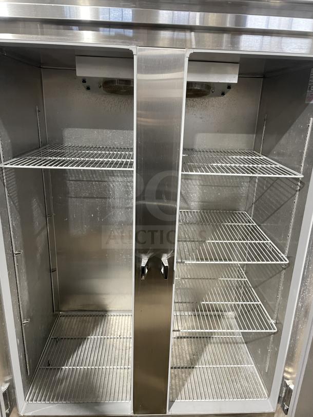 Continental 2R Commercial Stainless Steel 2-Door Refrigerator with poly-coated wire racks, clean interior, on casters.