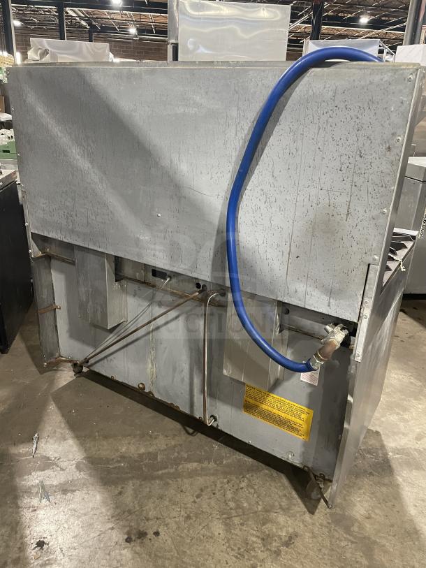 US Range stainless steel gas griddle/broiler with 6-burner range, 2 ovens, model PX-6-24BG-2626, on casters, back view.