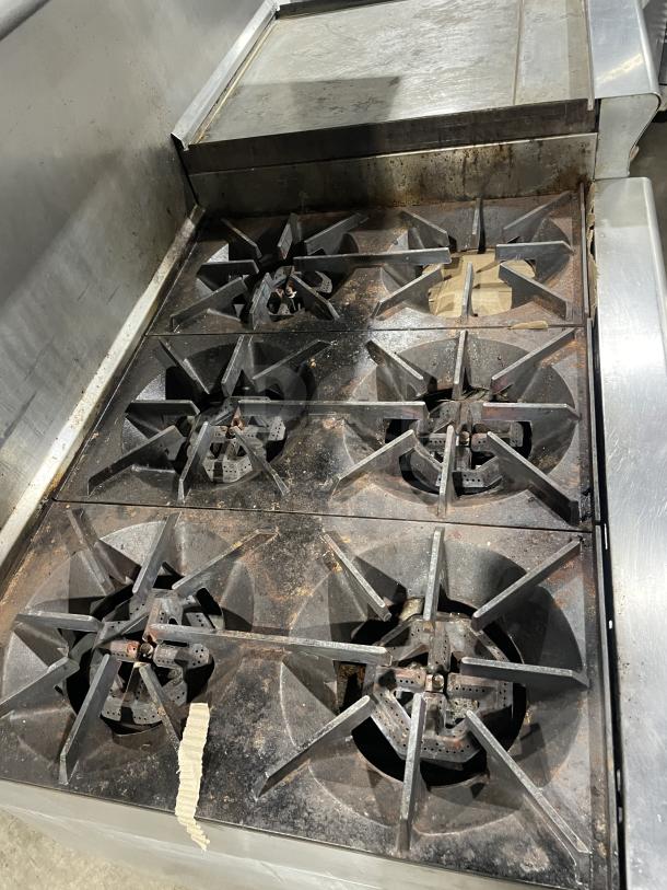 Us Range stainless steel griddle/broiler with 6-burner range and 2 ovens, model PX-6-24BG-2626, on casters.