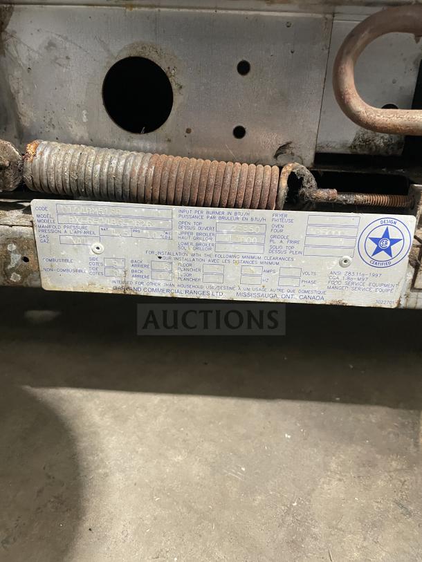 US Range stainless steel griddle/broiler, Model PX-6-24BG-2626, SN: 0104PM518R, with 6-burner range and 2 ovens on casters.