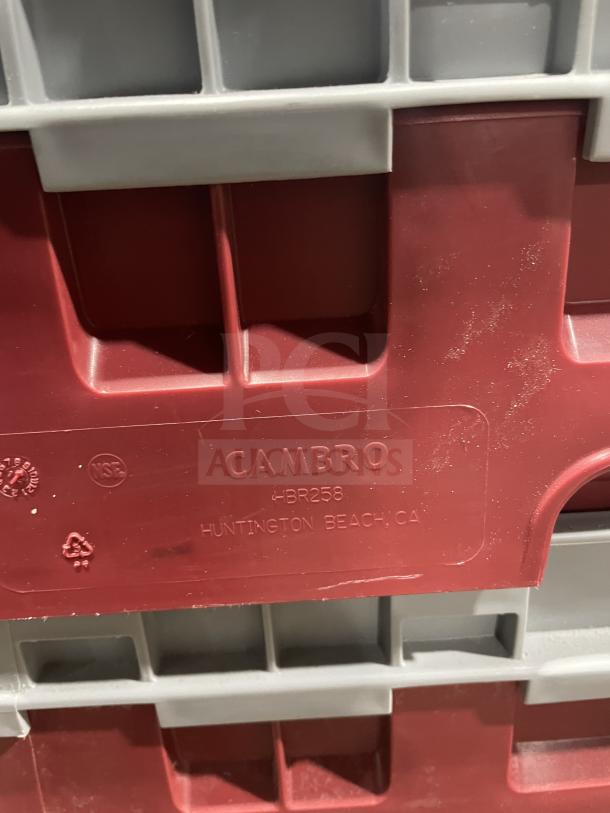 Cambro commercial dish washer rack, model 10HS318, red and gray, with labels indicating NSF certification and recycling info.