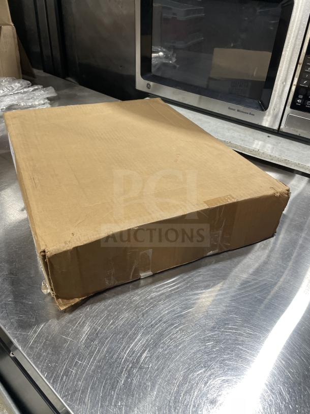 Sealed box of Carlisle NCT1418 black 14"x18" trays on a metal surface. Brand new condition. Contains 12 pieces.