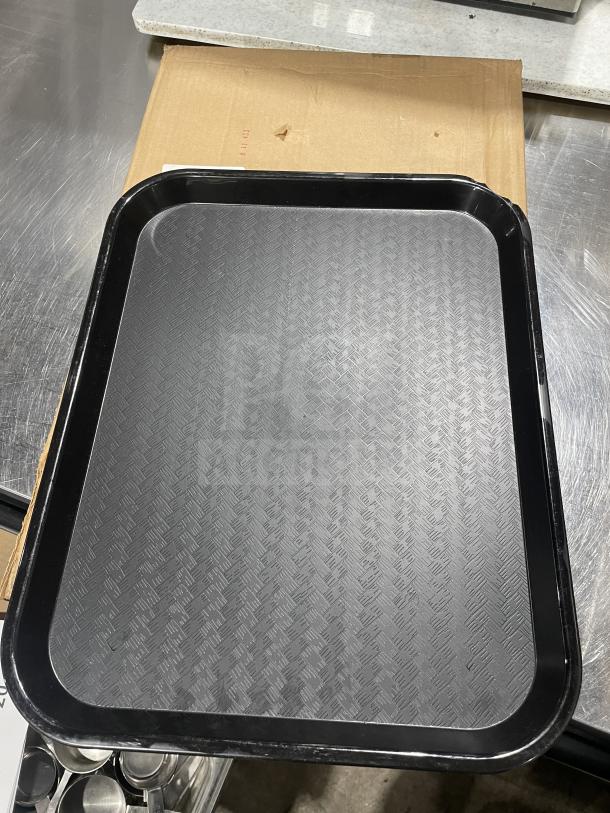 Brand new Carlisle 14"x18" black fast food serving tray, textured surface, commercial quality, pristine condition.