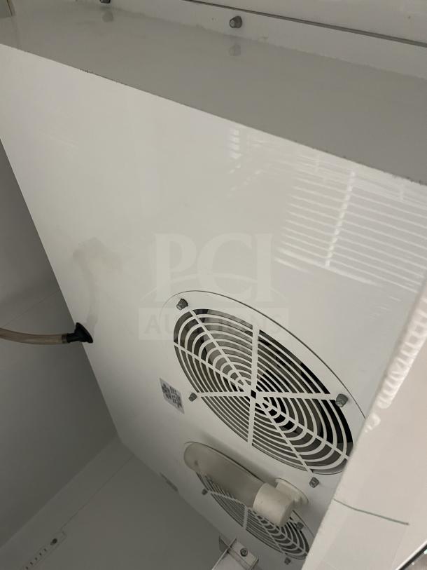 True T-49F commercial stainless steel 2-door freezer, Energy Star certified, with poly-coated wired racks, 115V, serial number 768945.