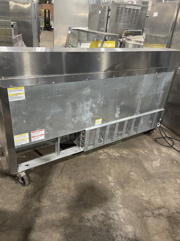 Beverage Air stainless steel pizza prep table, model SPE72HC-18, 3-door refrigerator, on casters, 115V/60Hz/1 phase.