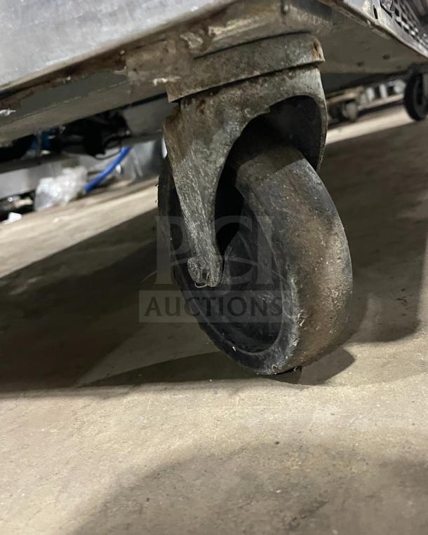 Beverage Air Model SPE72HC-18 stainless steel pizza prep table caster wheel.