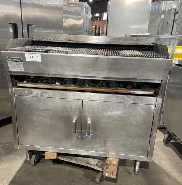 Rankin Delux stainless steel countertop char broiler grill, natural gas-powered, features back and side splashes, on legs, visible wear.