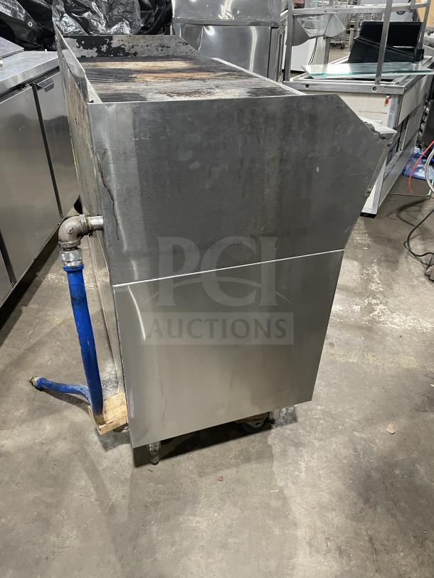 Rankin Delux stainless steel countertop char broiler grill, natural gas powered, with back and side splashes, on legs.