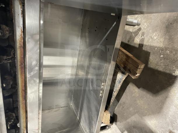 Rankin Delux stainless steel countertop char broiler grill with back and side splashes, natural gas powered, on legs.