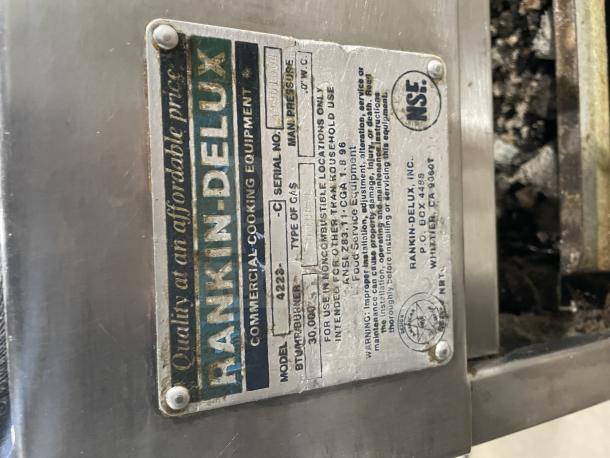 Rankin Delux stainless steel char broiler grill, model 4223C, with back and side splashes, on legs. Uses natural gas.