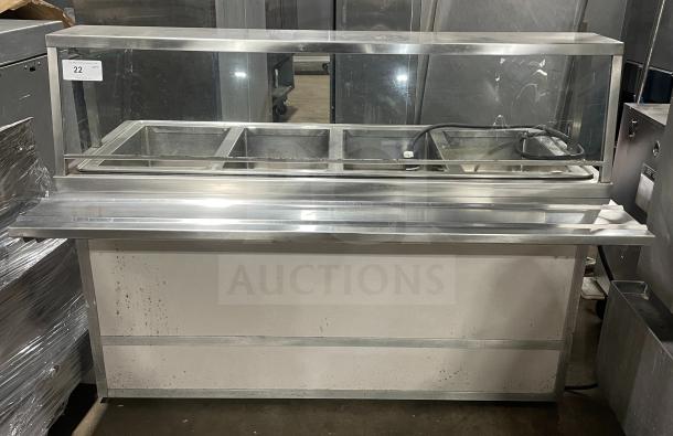 Atlas Model WIH-D&M-4, stainless steel 4-well hot food steamtable with sneeze guard, tray slide, storage base, 208V, on casters.