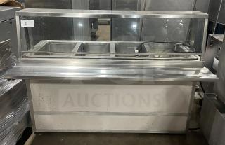 Atlas Model WIH-D&M-4, stainless steel 4-well hot food steamtable with sneeze guard, tray slide, storage base, 208V, on casters.