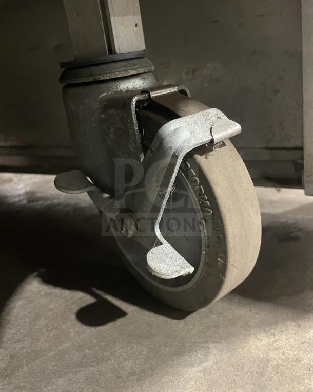 Caster wheel of Atlas WIH-D&M-4 electric steamtable, showing sturdy metal construction and mobility feature.